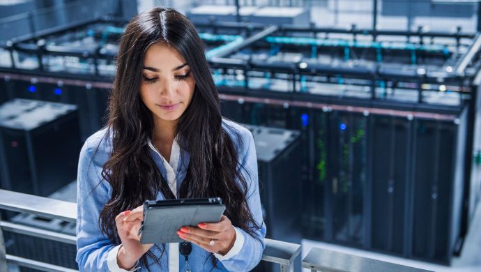 Woman on tablet in data centre